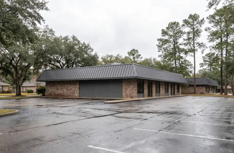 grey commercial metal roof on a brick strip-mall unit